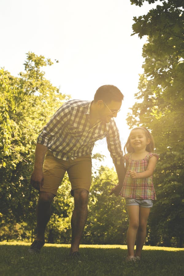 Single father running in the meadow with daughter. stock image Single father running in the meadow with daughter. stock image