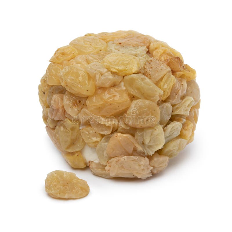 Single goat cheese covered with marinated raisins on white background stock photo