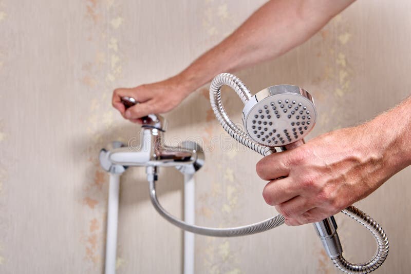 Plumber Fixing Leaky Single Handle Shower Faucet in Bathroom. Stock