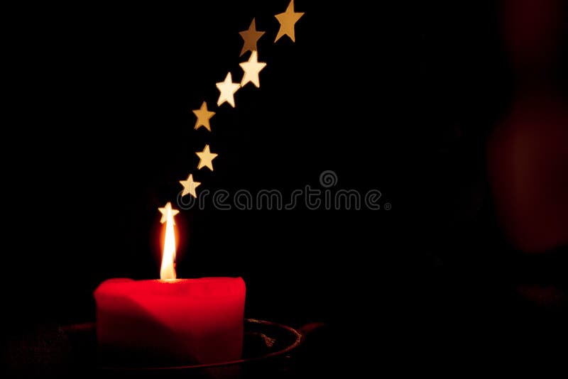 Single candle in the dark with stars instead of smoke stock photography Single candle in the dark with stars instead of smoke stock photography