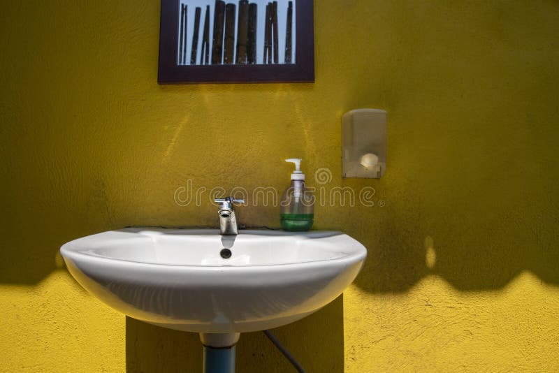 Single Sink Vanity and Skylights in Bathroom in Yellow Tones Stock