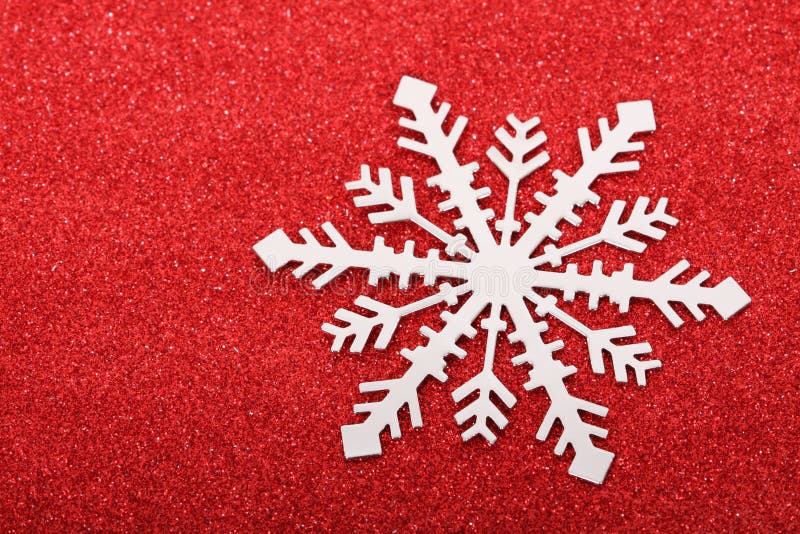 Single snowflake on red background stock images