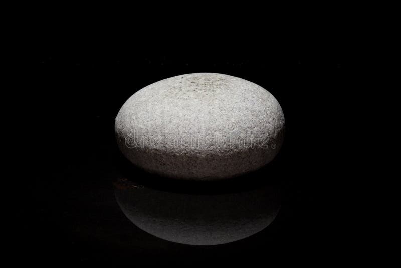 Single stone - dark background - zen concept