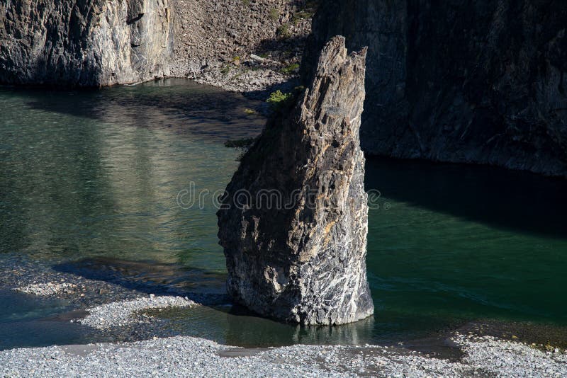 Single stone pillar in the riverbed.