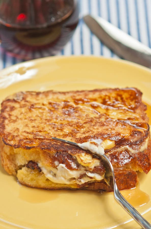 Single stuffed French toast being cut with an artisan fork