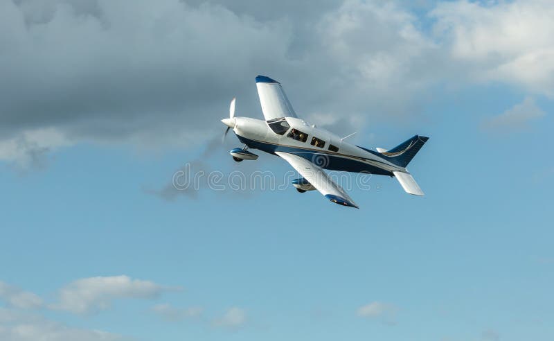 Single piston aircraft. Single-propeller aircraft flying over the blue sky at a small airport. Single piston aircraft. Single-propeller aircraft flying over the blue sky at a small airport