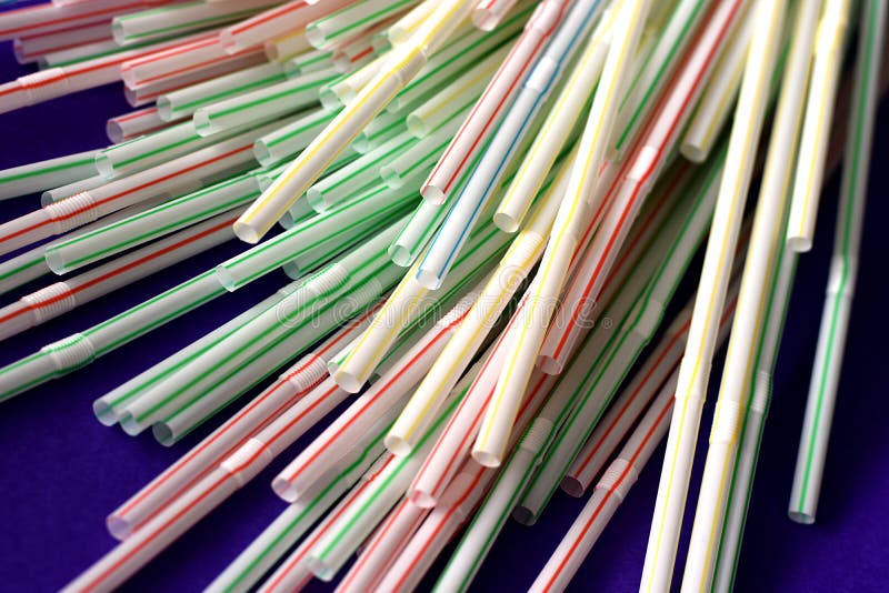 Colorful Single Use Disposable Plastic Straws on Pink Surface Stock