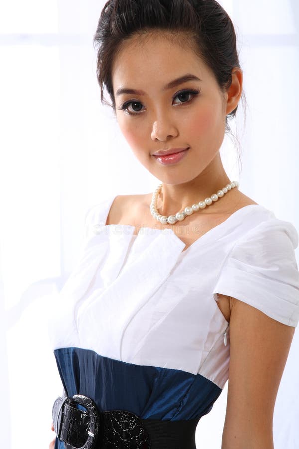 Single young woman with blue and white skirt.