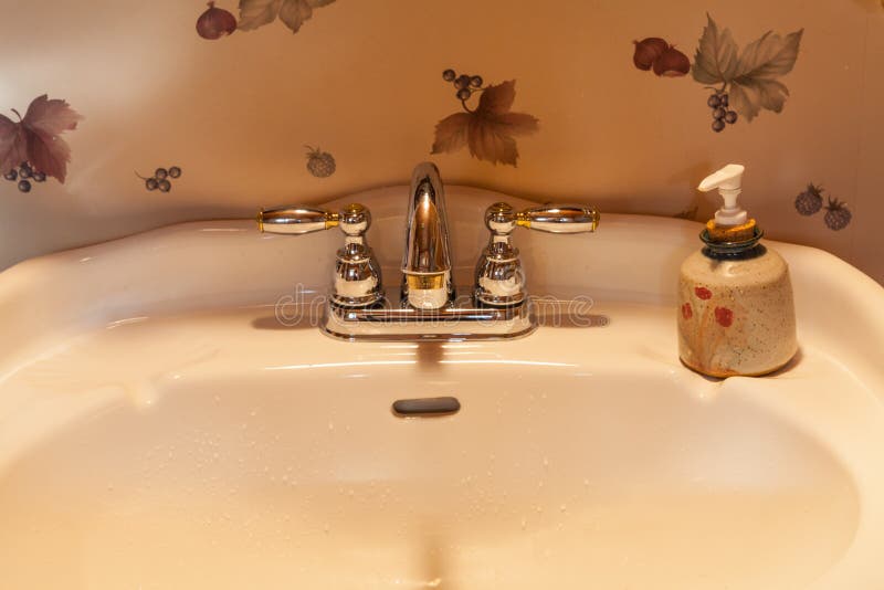 Sink Fixture in a Wallpapered Bathroom Stock Image - Image of river