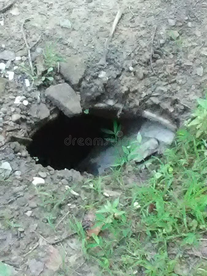 Sink hole in the yard. stock photo. Image of hole, tunnel 154015232