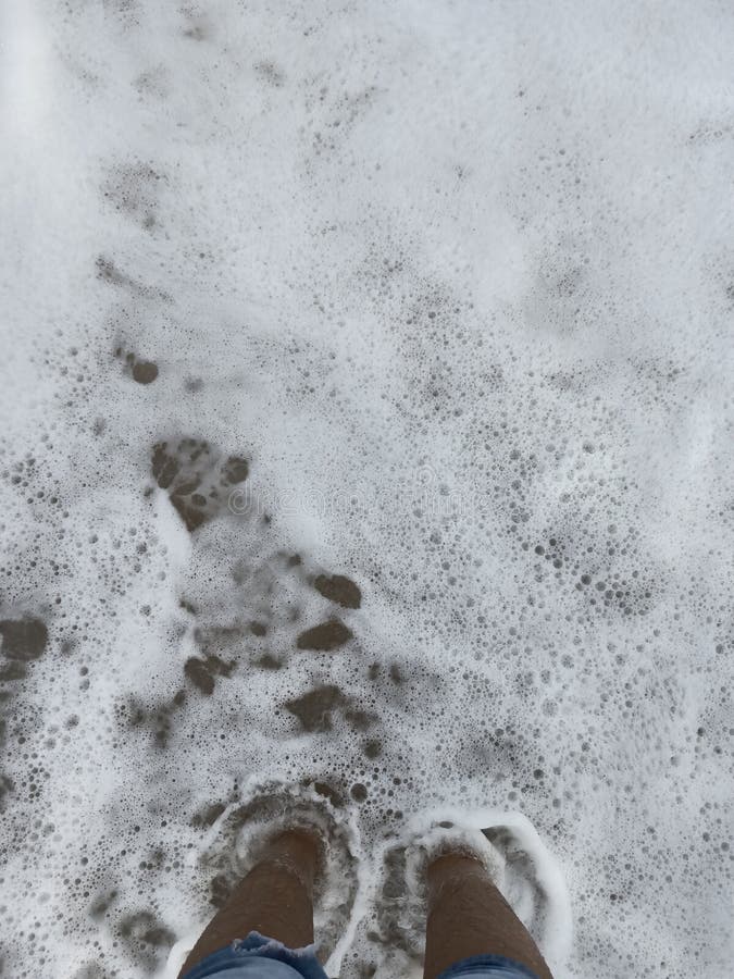Sinking feet. Beach. Wave. royalty free stock photo