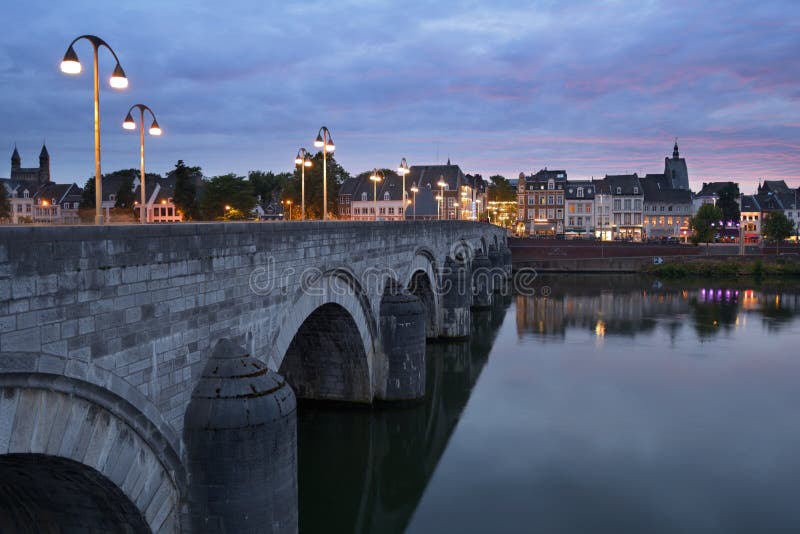 Maastricht, Netherlands - September 7, 2013: Sint-Servaasbrug, the bridge of St. Servatius across the Meuse river in evening. Built in XIII century, it considered as the oldest Dutch bridge. Maastricht, Netherlands - September 7, 2013: Sint-Servaasbrug, the bridge of St. Servatius across the Meuse river in evening. Built in XIII century, it considered as the oldest Dutch bridge