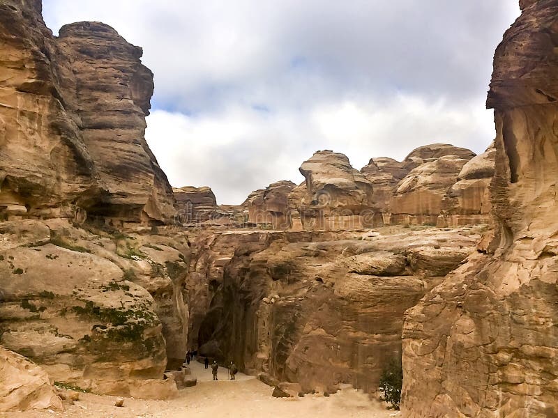 The Siq, the narrow slot-canyon that serves as the entrance passage to the hidden city of Petra stock images