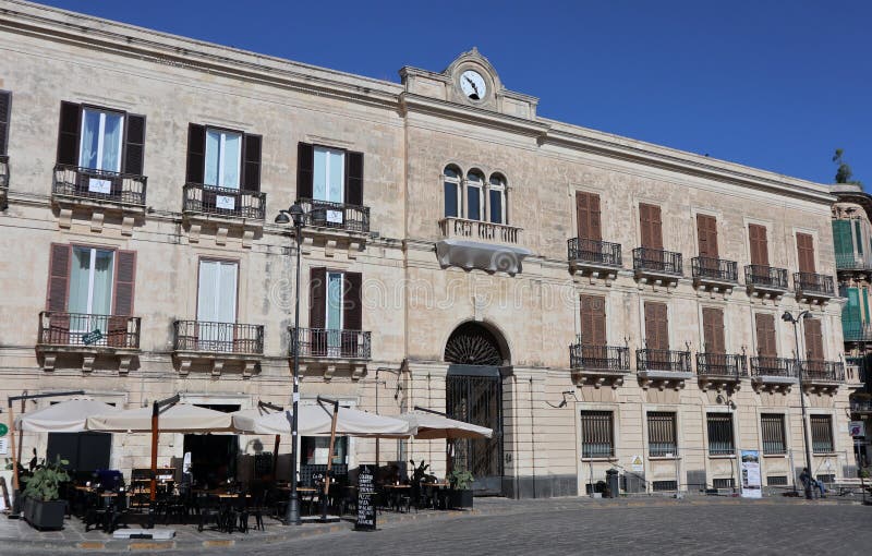 Syracuse, Sicily, Italy - August 26, 2020: Palazzo Platamone or Palazzo dell`Orologio in Piazza Archimede, headquarters of the Bank of Italy. Syracuse, Sicily, Italy - August 26, 2020: Palazzo Platamone or Palazzo dell`Orologio in Piazza Archimede, headquarters of the Bank of Italy