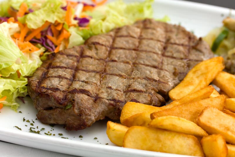 Sirloin steak with chips ,mushrooms,salad stock photography