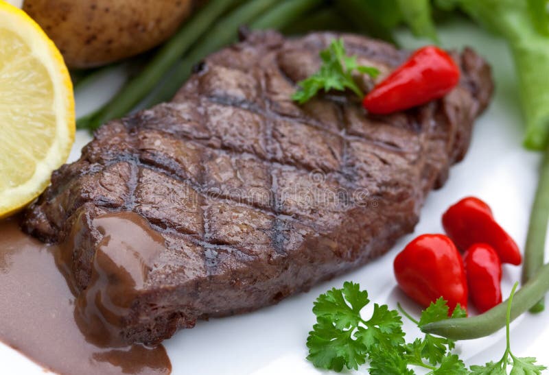 A Sirloin Strip Steak with Vegetables and Savory Stock Photo Image of