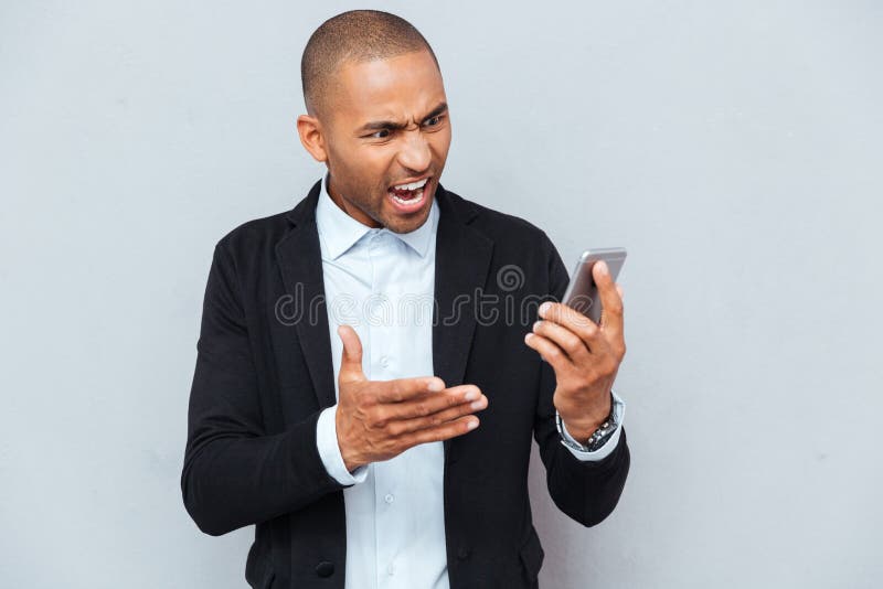 Sirva señalar con el finger en el fondo elegante del gris del teléfono imagenes de archivo Sirva señalar con el finger en el fondo elegante del gris del teléfono imagenes de archivo