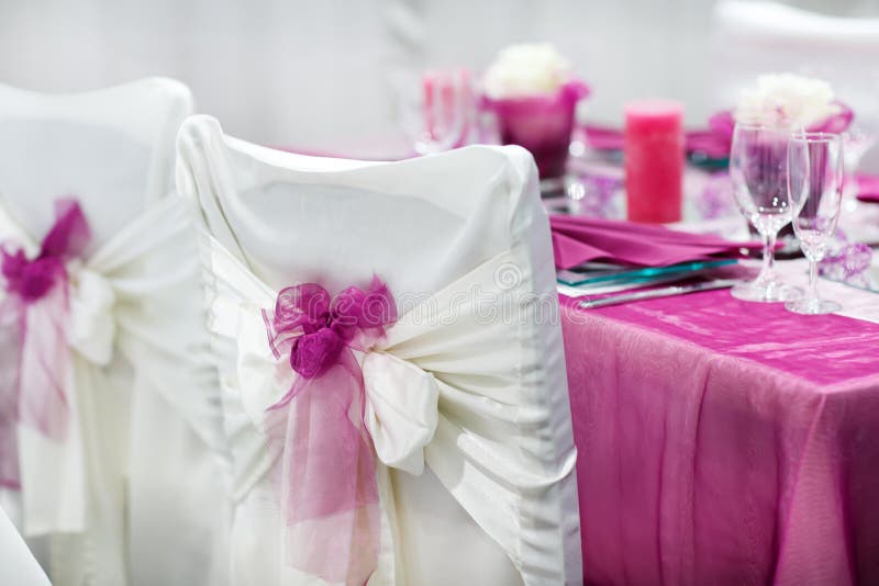 Table set for wedding or event party in pink, rose and purple. Table set for wedding or event party in pink, rose and purple
