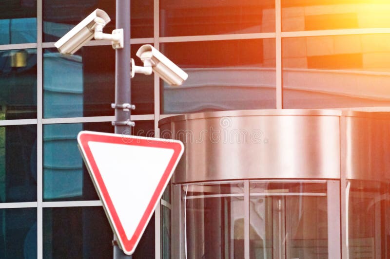 Sistema de vigilância da segurança na entrada a um prédio de escritórios moderno Duas câmeras da fiscalização video imagens de stock royalty free Sistema de vigilância da segurança na entrada a um prédio de escritórios moderno Duas câmeras da fiscalização video imagens de stock royalty free