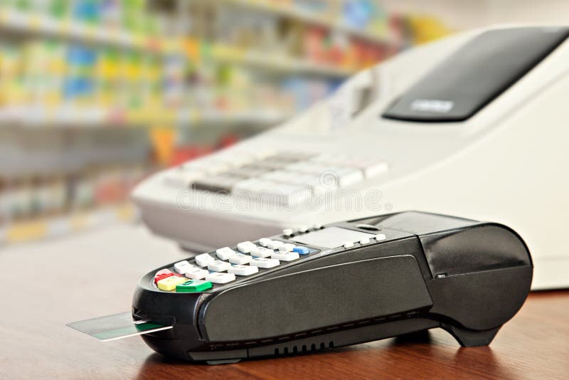 Close up of Credit Card Reader and Cash Register on background of Retail Shelves. Close up of Credit Card Reader and Cash Register on background of Retail Shelves