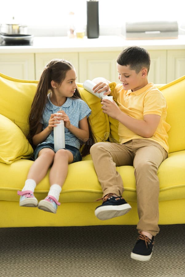 Sister And Brother Eating Cream On Sofa Stock Image Image Of Adorable