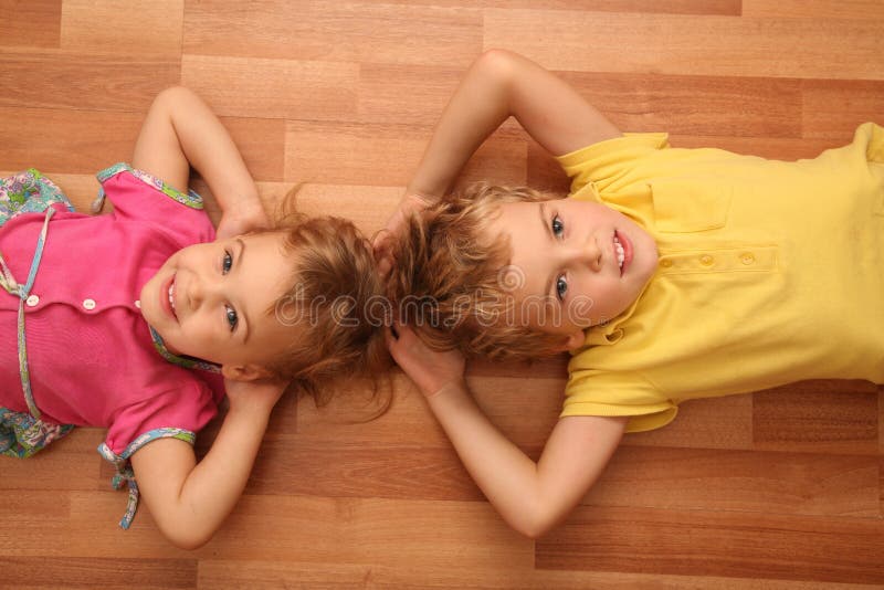 Sister and brother lie on floor