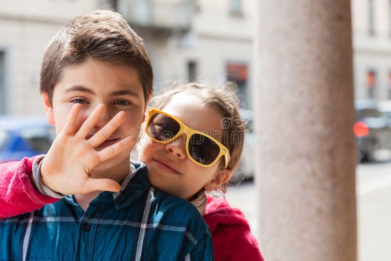 Child covers his mouth of her brother, portrait stock image Child covers his mouth of her brother, portrait stock image