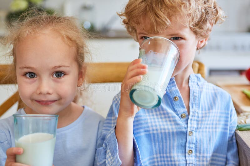 Brother And Sister Sharing Glass Of Milk High-Res Stock Photo - Getty Images