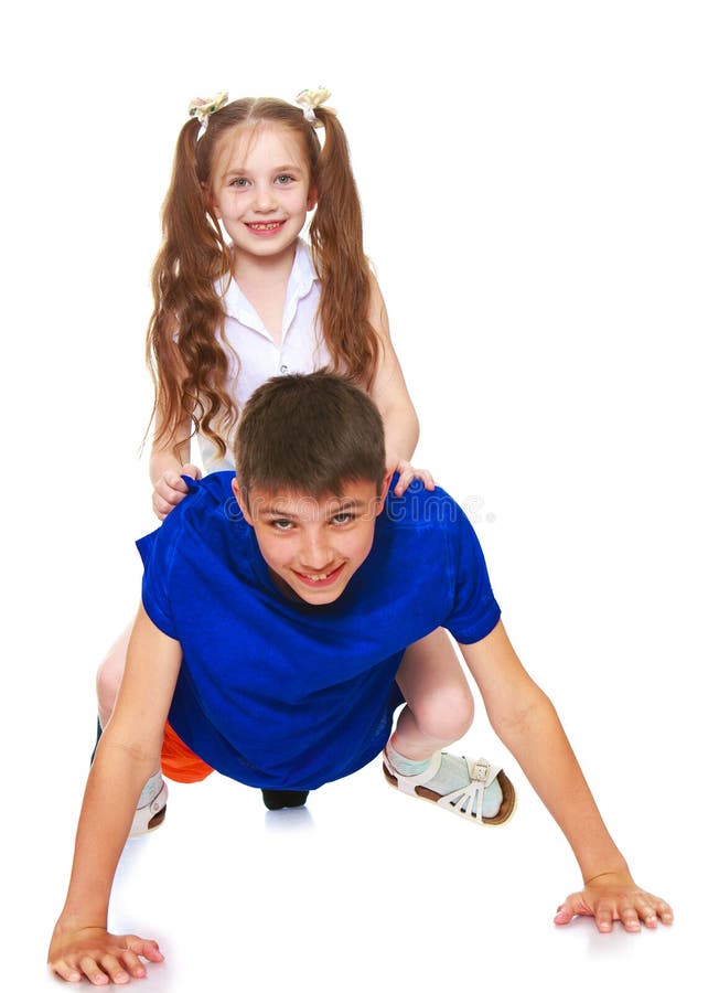 Sister sits on the back of a brother stock images.