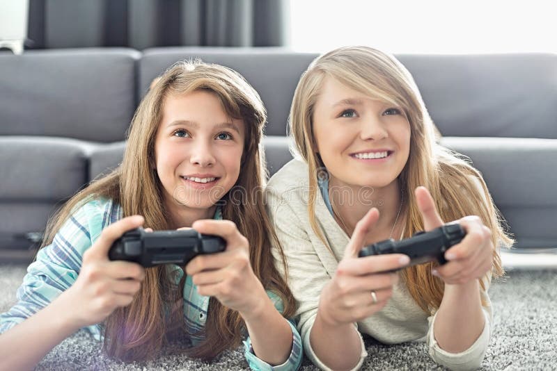 Two sisters play games - a Royalty Free Stock Photo from Photocase