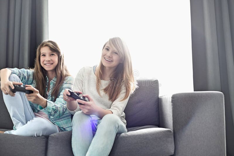 Two sisters play games - a Royalty Free Stock Photo from Photocase