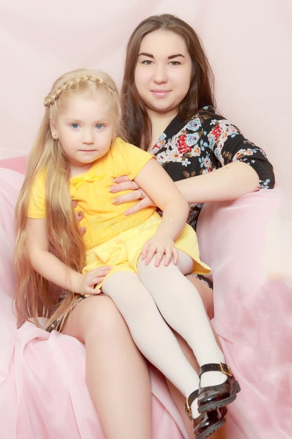 2 Sisters are Sitting on the Couch. Stock Image Image of longhaired
