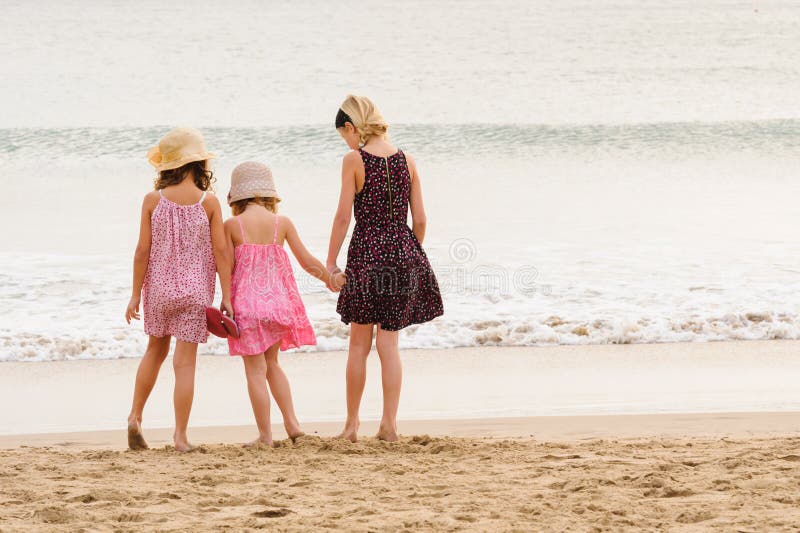 3 sisters stand on beachfront facing the ocean. royalty free stock photo 3 sisters stand on beachfront facing the ocean. royalty free stock photo