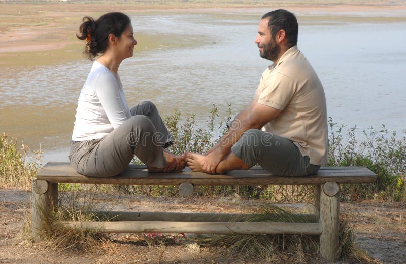 Couple sitting together on park bench. Couple sitting together on park bench