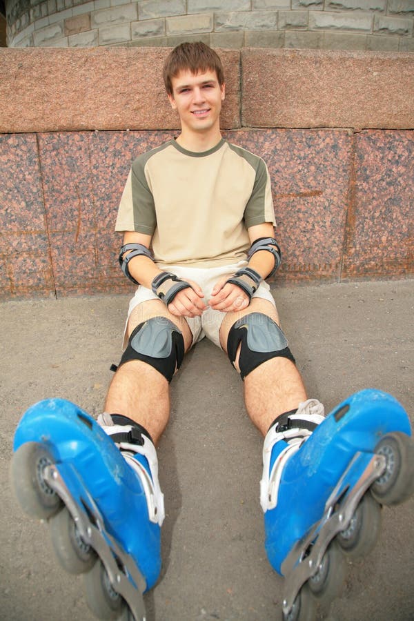 Sitting guy in rollerblades