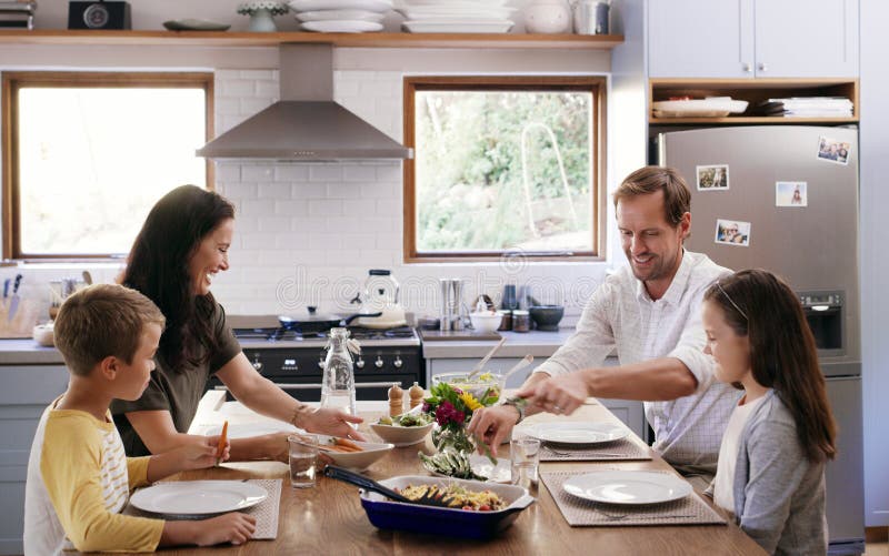 Sitting at a Table Called Happiness. Two Affectionate Young Parents