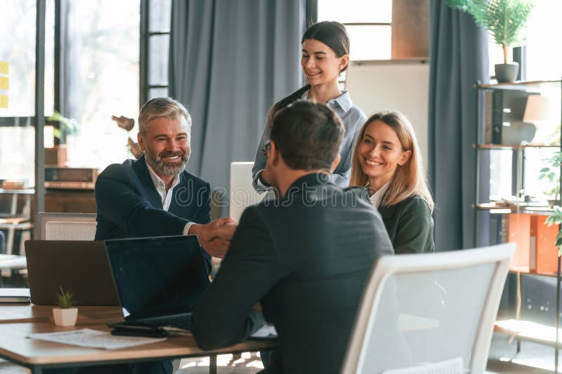 Sitting by the Table. Group of Business People are Working in the