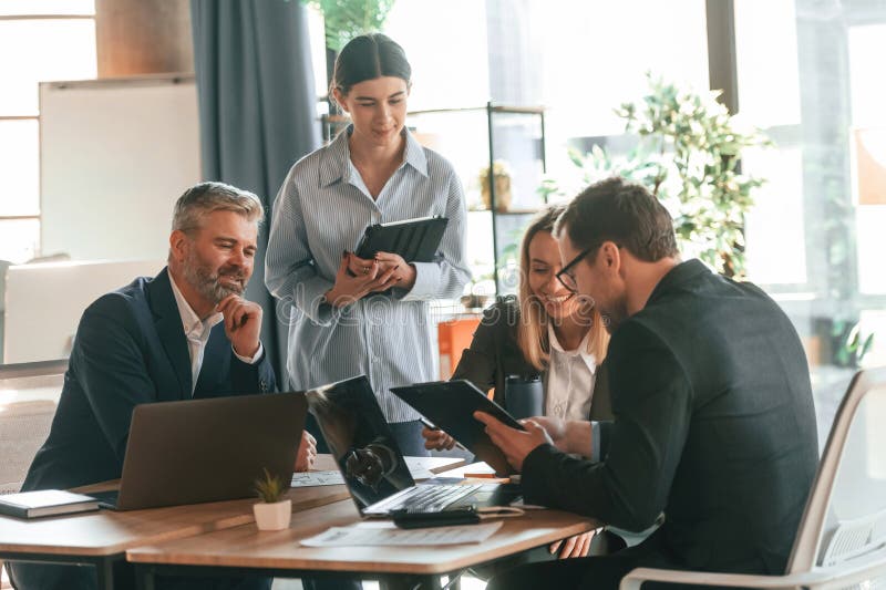 Sitting by the Table. Group of Business People are Working in the