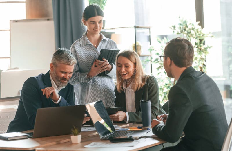 Sitting by the Table. Group of Business People are Working in the