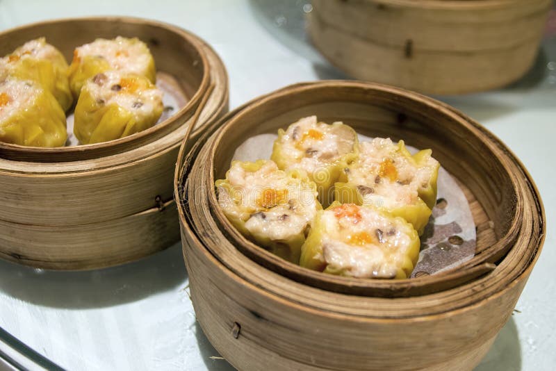 Siu Mai Steamed Pork and Shrimp Dumplings Topped with Fish Roe in Bamboo Steamer Closeup