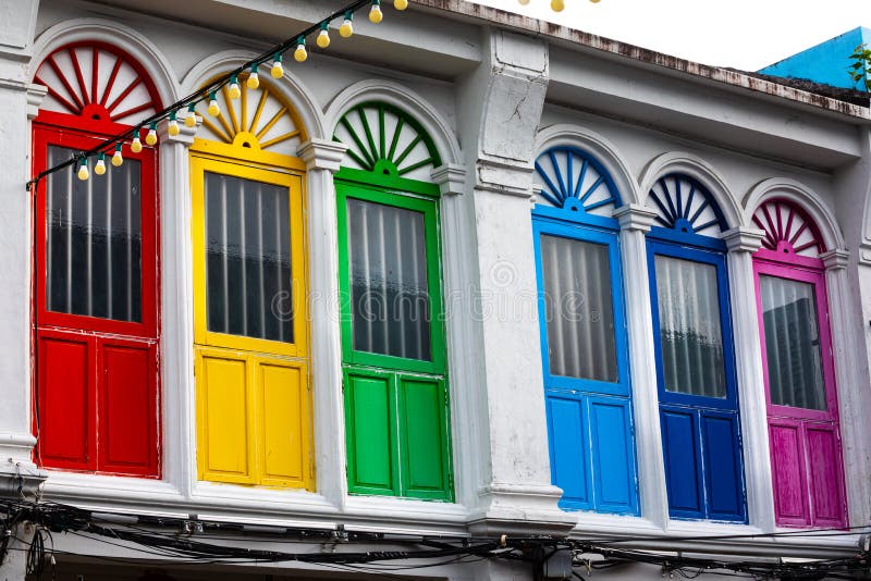 Six colorful doors or windows outside on the facade of an ancient house