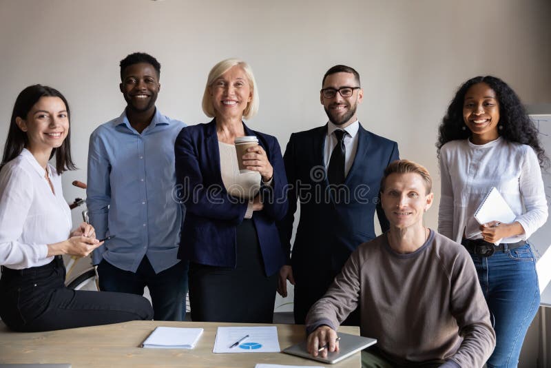 Six confident businesspeople international department successful employees posing in office stock image Six confident businesspeople international department successful employees posing in office stock image