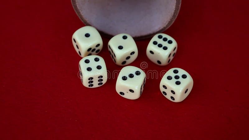 Six dice with cup on red rotating table stock footage
