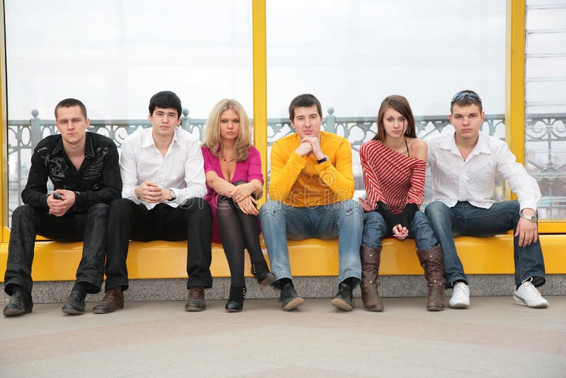 Six young persons sit