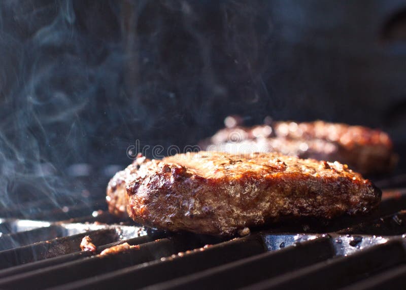 Sizzling hamburgers on the grill