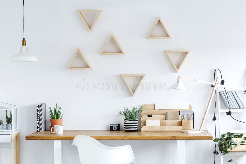 Wooden desk with cup of coffee camera and cactus in clay pot in bright home office. Wooden desk with cup of coffee camera and cactus in clay pot in bright home office