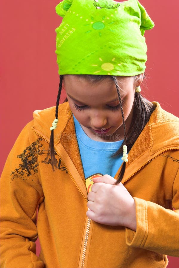 Young girl zipping a sweatshirt. Young girl zipping a sweatshirt