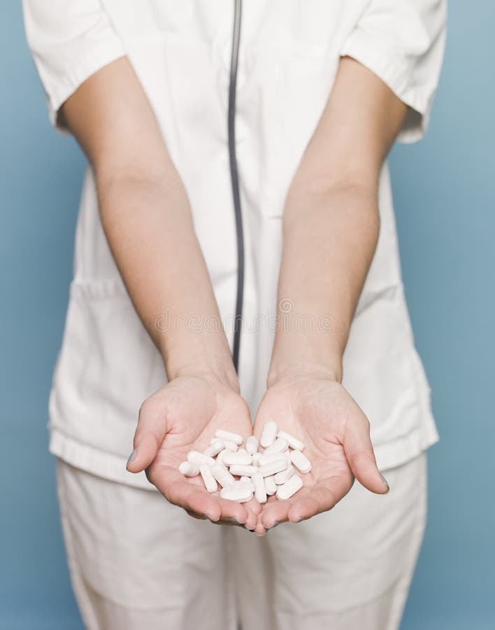 Nurse with several pills in her hands. Nurse with several pills in her hands