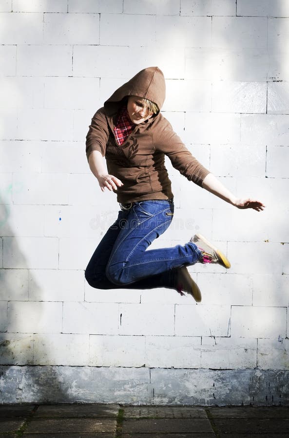 Young girl jumping against the wall. Young girl jumping against the wall.