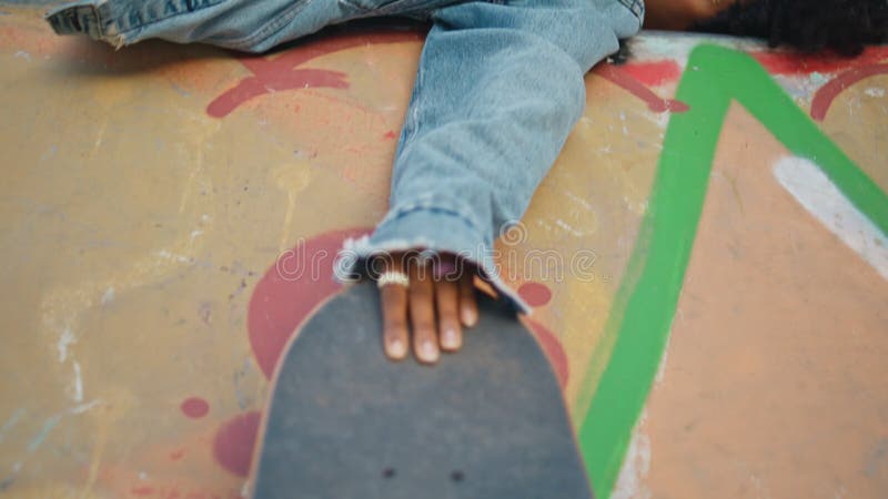 Skateboard moderno pattinatore con una ragazza pattinatrice per strada con graffiti chiusi.